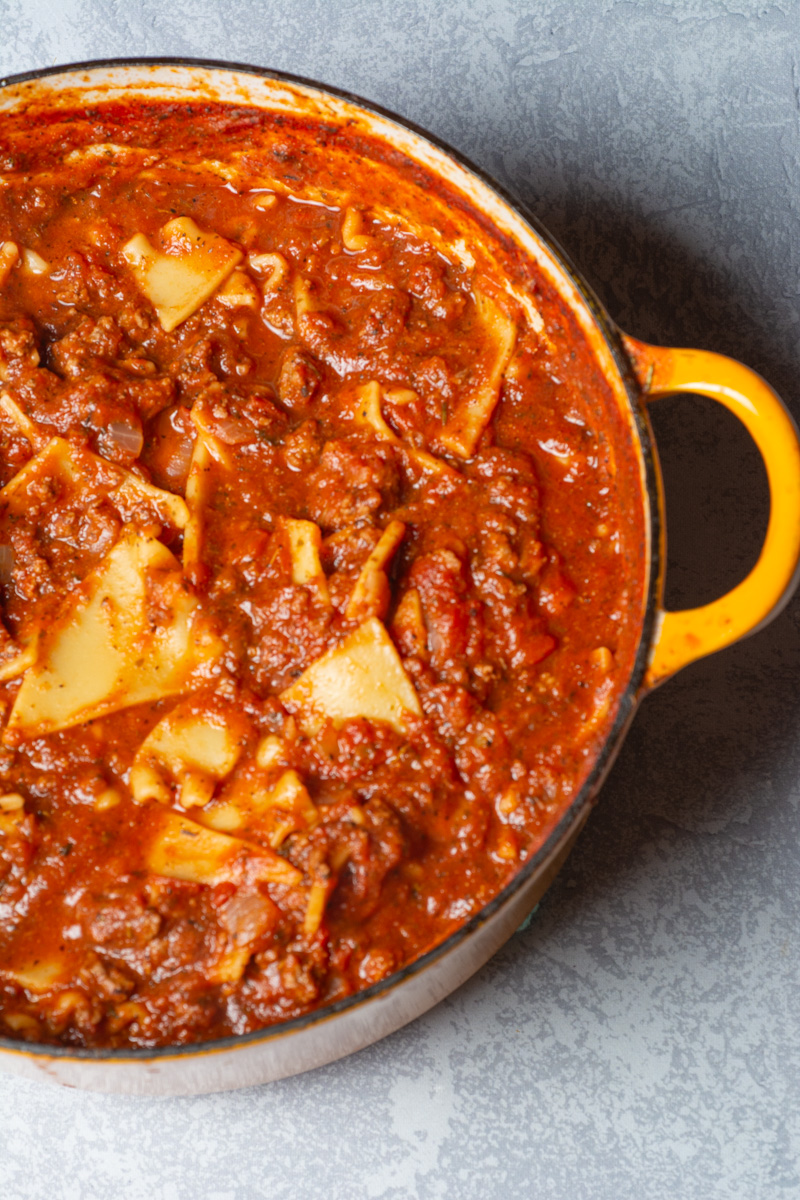 One pot lasagna soup in a yellow dutch oven.